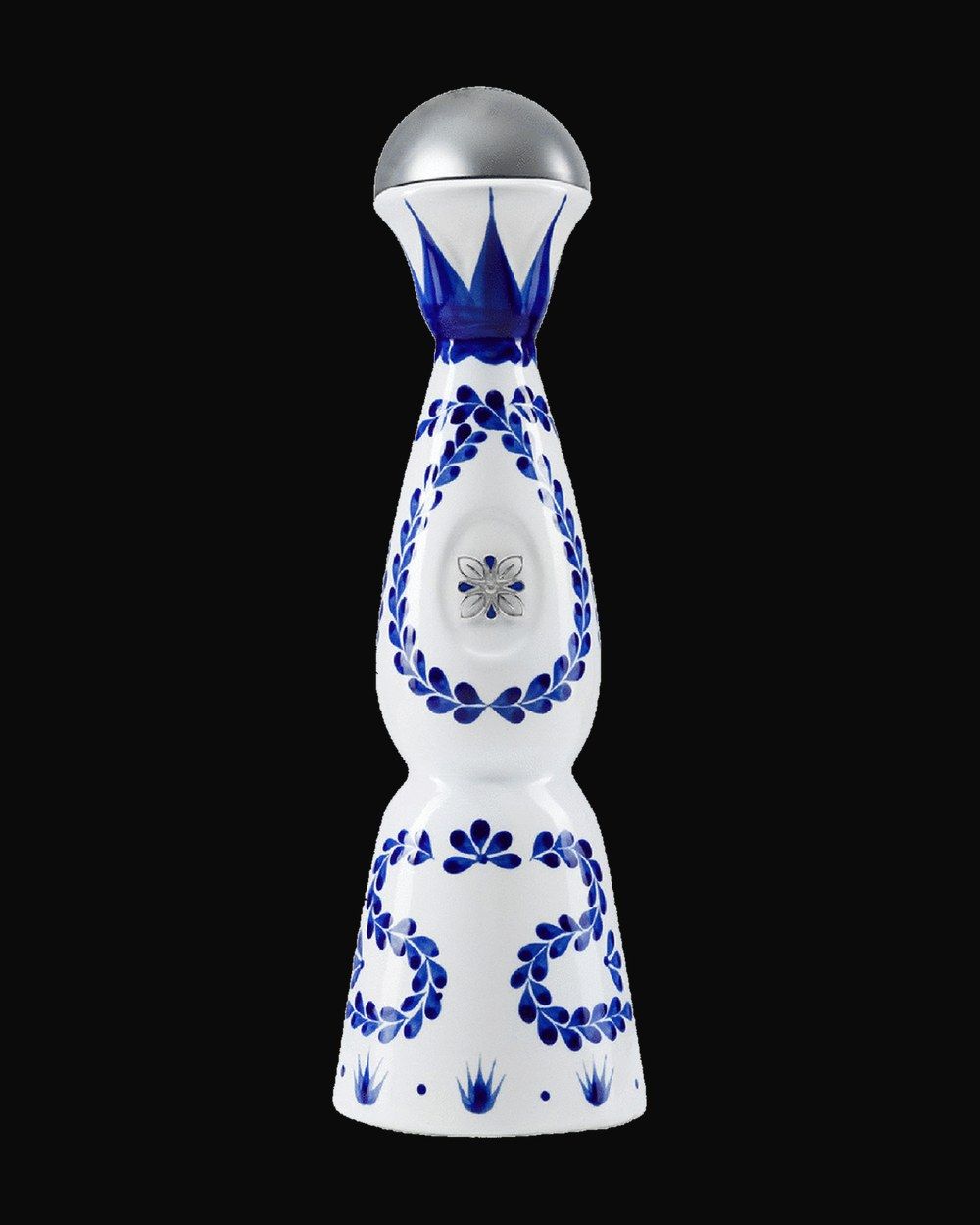 Bottle of Clase Azul Reposado, tequila, from Jalisco, Mexico, 750ml — a clear agave spirit bottle on charred stone with lime and salt