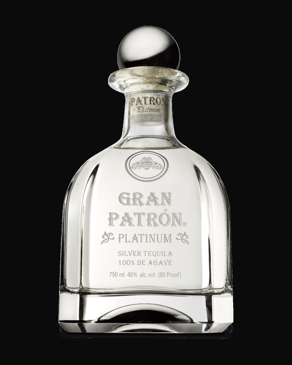Bottle of Patrón Gran Patrón Platinum, tequila, from Jalisco, Mexico, 750ml — a clear agave spirit bottle on charred stone with lime and salt